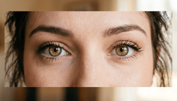 Close-up of green eyes with defined eyebrows and natural makeup